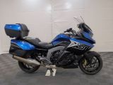 a blue and black motorcycle parked in a garage
