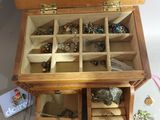 a wooden box filled with jewelry and a pair of scissors