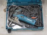 a blue tool box with a drill and other tools in it