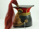 a small hat with a long red hair on it