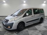 a picture of a silver van parked on a checkered floor