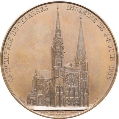 une pièce de monnaie en bronze sur laquelle est représentée une cathédrale
