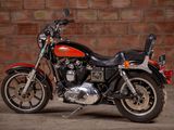 a motorcycle that is parked in front of a brick wall