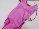 a pink bag that is laying on a table