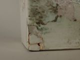 a white box with a painting on it sitting on a table
