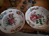 two plates with flowers on them on a table