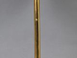 a black and gold table lamp with a black shade
