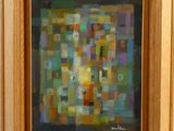 une peinture à l'huile représentant un tableau composé de carrés de différentes couleurs sur un châssis en bois