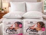 deux oreillers posés sur un lit dans une chambre, à côté d'un oreiller