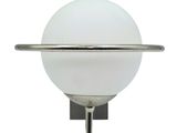 an image of a wall mounted light with a glass ball on it