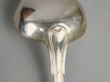 a silver spoon with a heart on it on a table