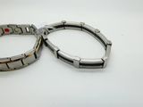 two bracelets that are sitting on a table