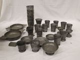 a lot of old pots and pans on the table