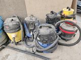 a lot of vacuums that are sitting on the ground