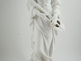 a white statue of a woman holding a basket