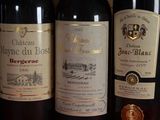 three bottles of wine sitting on top of a wooden table