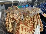 many clothes hanging on a rack in a closet