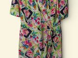 an image of a dress hanging on a hanger on a wall