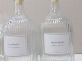 three bottles of water sitting on a table next to each other