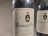 two bottles of wine sitting next to each other on a table