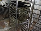 many racks of food in a kitchen that is being prepared
