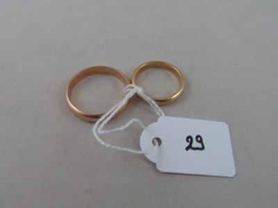 a pair of gold wedding rings with a price tag