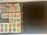 a black binder with a lot of stamps on it