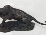 statue of a lion on a rock on a white background