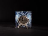 a small glass plate with a button on it