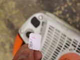 a person holding a small piece of paper with a sticker on it