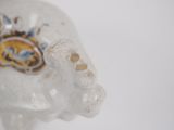 a white elephant figurine with a blue and yellow design on it