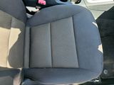 the interior of a car with a black seat and a black steering wheel