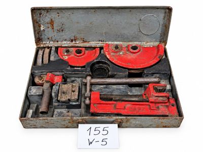 a box with tools in it on a white surface