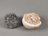 two rocks sitting next to each other on a table