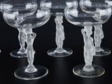 many wine glasses that are lined up on a table