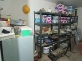 an image of a room with a refrigerator and shelves in it