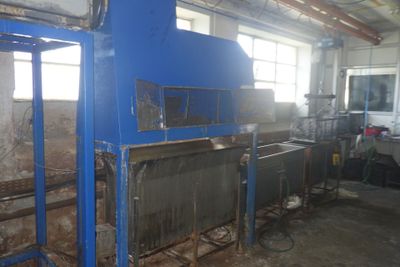 une machine bleue qui se trouve dans un bâtiment avec beaucoup de fenêtres