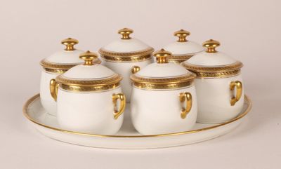 six white and gold sugar and creamer set on a tray