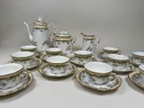 a lot of cups and saucers that are on the table