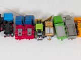 many toy trains that are lined up together on the wall