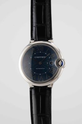 a close up of a wrist watch with a black leather strap
