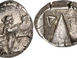 a silver coin with an image of a woman on it