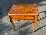 a small wooden table with a drawer on top of it