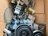 a cardboard box filled with cameras and other electronic equipment