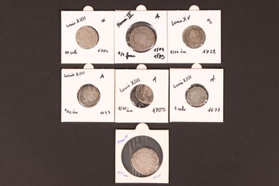 several different types of coins are displayed on a black surface