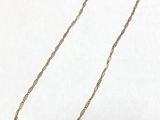 a close up of a necklace on a white surface