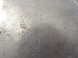 a silver plate with a handle on it on a table
