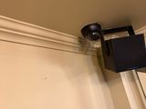 an image of a camera mounted on the wall of a house