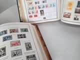 an open book sitting on top of a table with stamps on it