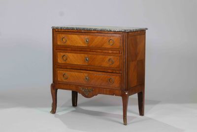 a small chest of drawers with marble top on it